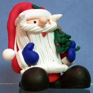 Santa - stands holding Xmas tree