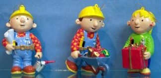 Bob - Painter stands holding pail  and plans